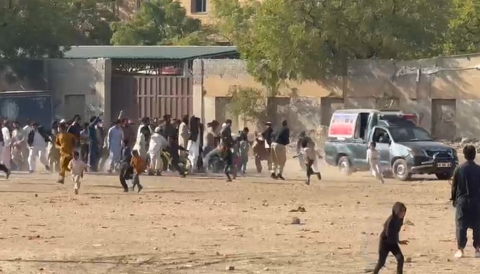 People pelt stones at a police vehicle in Karachi on January 11, 2026. — Reporter