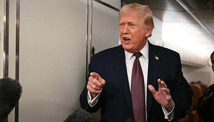 US President Donald Trump speaks to the press aboard Air Force One on January 11, 2026. — AFP