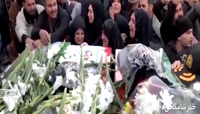 Mourners react next to coffins during a funeral procession for members of security forces and civilians said to be killed in protests on Sunday, in Tehran, Iran, in this screengrab from a video released on January 11, 2026. — Reuters