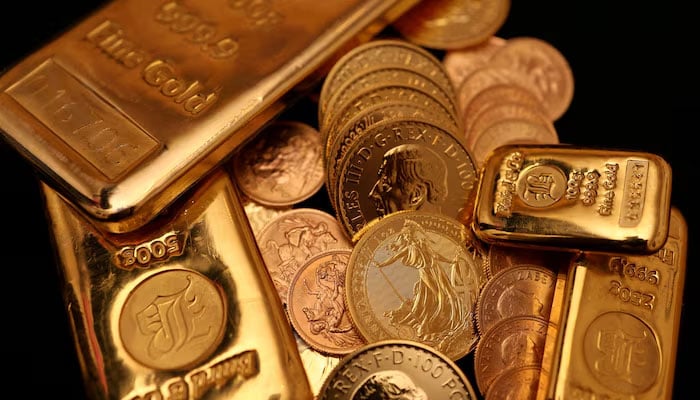 Gold bars and gold Sovereign coins are displayed at Baird & Co in Hatton Garden in London, Britain on  October 8, 2025. — Reuters