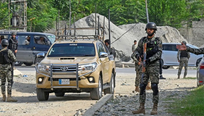 Security personnel stand guard in Bajaur district of Khyber-Pakhtunkhwa on July 31, 2023. — AFP