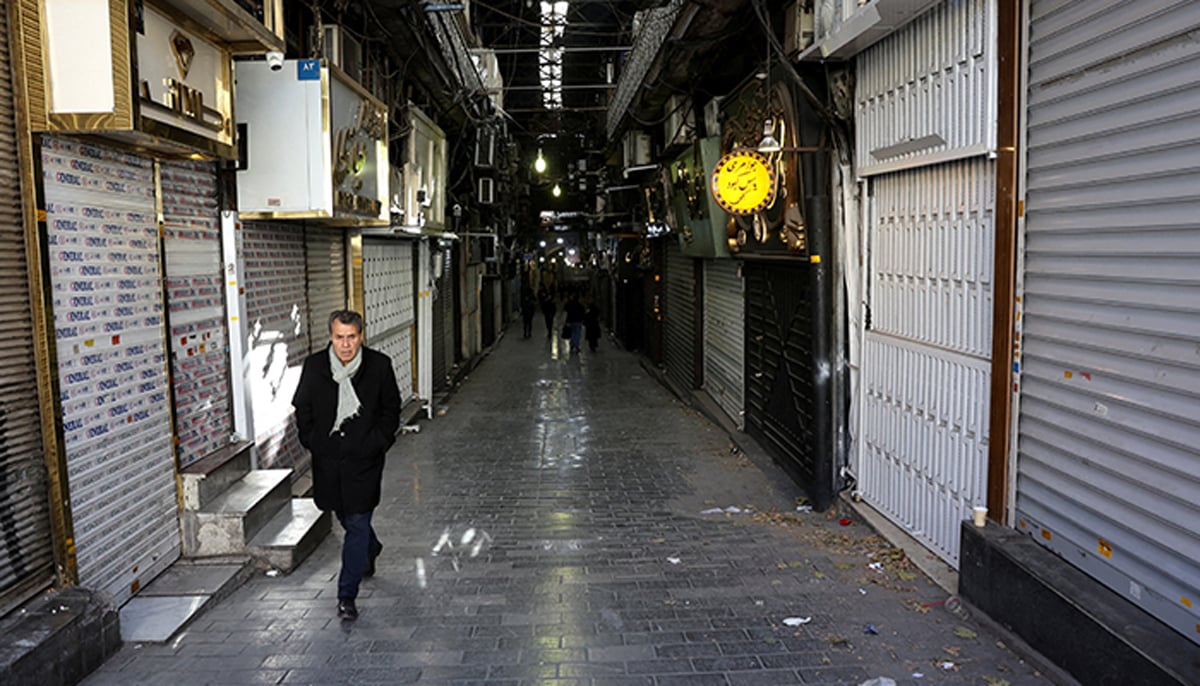 People walk past closed shops following protests. — Reuters