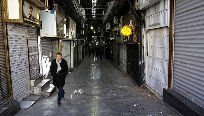 People walk past closed shops following protests. — Reuters
