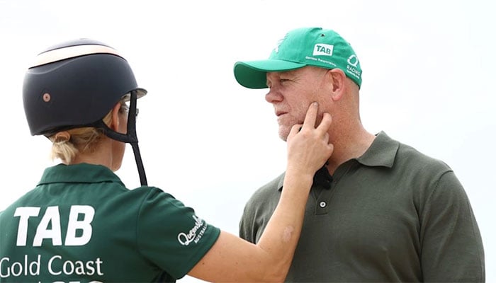 Zara and Mike dressed in matching Magic Millions gear
