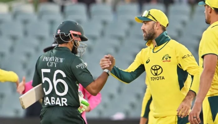 Pakistans Babar Azam and Australian cricketer Glenn Maxwell shake hands after a match. — AFP