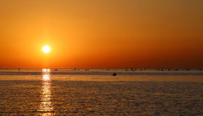 Tourists and locals paddleboard at the sunrise on the Mediterranean Sea in Barcelona, Spain July 2, 2025. — Reuters