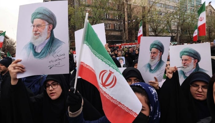 Iranian women hold portraits of Iran’s Supreme Leader Ayatollah Ali Khamenei during the funerals of security forces personnel killed in recent protests in Tehran on January 14, 2026. — AFP