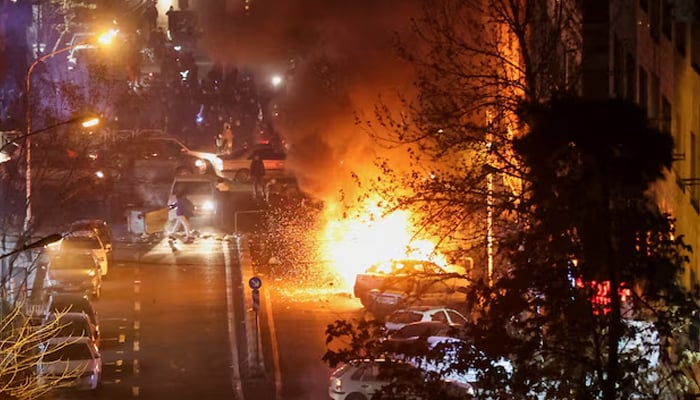 Cars burn in a street during a protest over the collapse of the currencys value, in Tehran, Iran, January 8, 2026. — Reuters