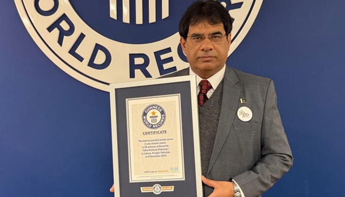 Pakistani senior tennis player Talha Waheed is seen with his Guinness World Record certificate for most serves in a minute. — Reporter