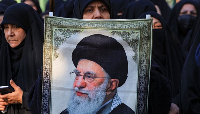A woman holds picture of Irans Supreme Leader Ayatollah Ali Khamenei during a rally in solidarity with Irans government in Tehran, near the Iranian Embassy in Baghdad, Iraq January 16, 2026.  — Reuters