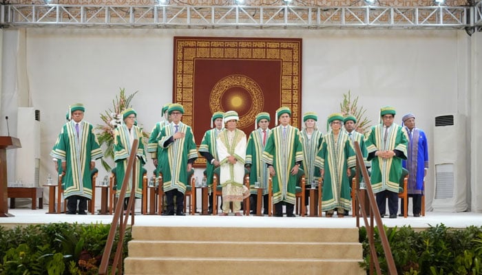 Aga Khan University teaching staff pose for a group photo during the 38th convocation. — AKU