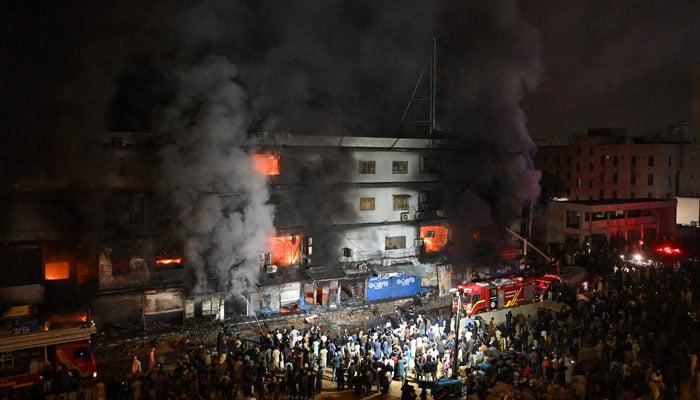 Firefighters douse a fire that broke out at a shopping mall in Karachi on January 18, 2026. AFP