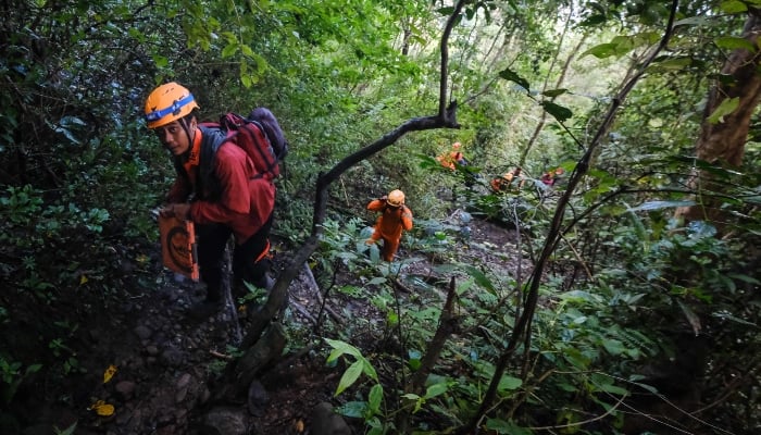 Joint search and rescue teams climb towards the suspected crash site of an Indonesia Air Transport turboprop plane that lost contact a day earlier while flying from Yogyakarta to Makassar, in the Bulusaraung Mountains, South Sulawesi, Indonesia, January 18, 2026. — AFP