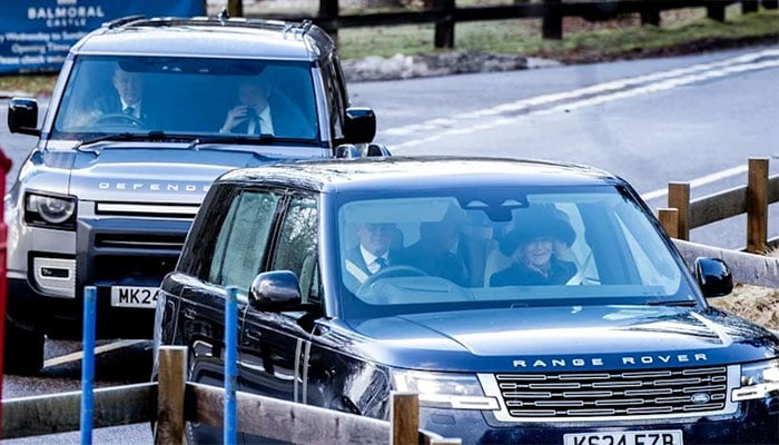 King Charles and Queen Camilla travelling in black Range Rover