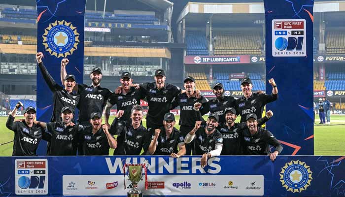 New Zealand´s players celebrate with the trophy after winning the series and the third one-day international (ODI) cricket match between India and New Zealand at the Holkar Cricket Stadium in Indore on January 18, 2026. — AFP