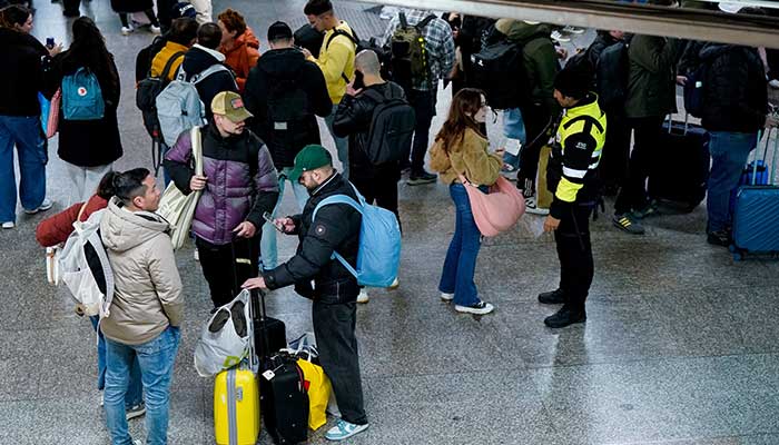 Passengers gather at the Atocha train station, amid train delays and cancellations, following a deadly derailment of two high-speed trains in Adamuz near, Cordoba, according to local police reports, in Madrid, Spain, January 18, 2026. — Reuters