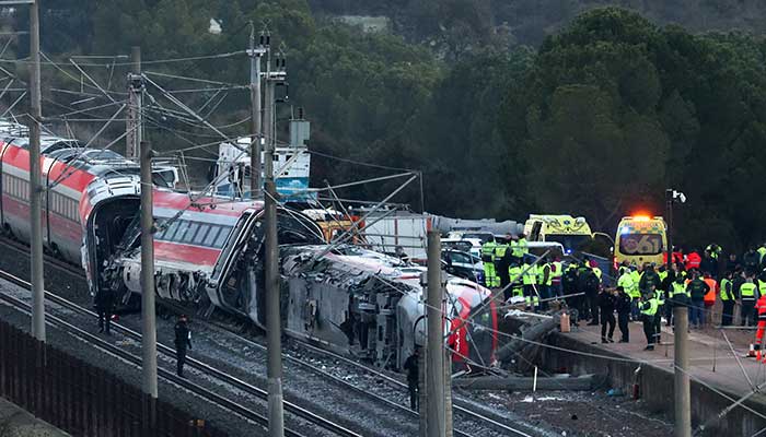 Members of the Spanish Civil Guard along with other emergency personnel work next to one of the trains involved in the accident, at the site of a deadly derailment of two high-speed trains near Adamuz, in Cordoba, Spain, January 19, 2026. — Reuters