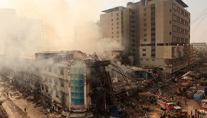 Workers remove debris following a massive fire that broke out in the Gul Plaza Shopping Mall in Karachi on January 19, 2026. — Reuters