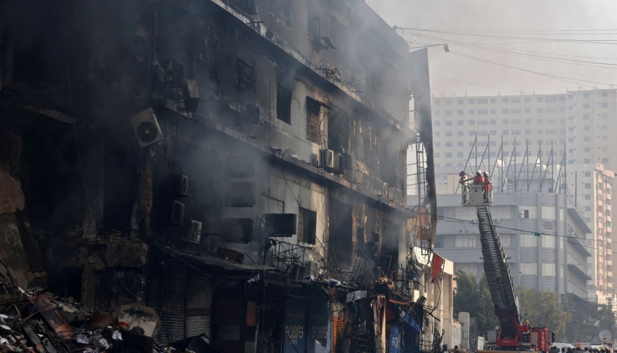 Firefighters work next to smouldering remains following a massive fire that broke out in the Gul Plaza Shopping Centre in Karachi,  January 19, 2026. — Reuters