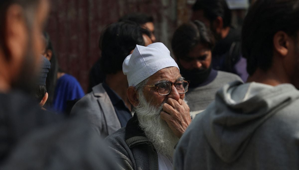 A man grieves after he lost his shop, following a massive fire that broke out in the Gul Plaza Shopping Mall in Karachi, January 19, 2026. — Reuters
