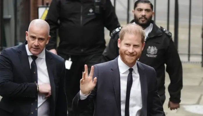 Prince Harry waves and receives good luck cheers on day two of trial