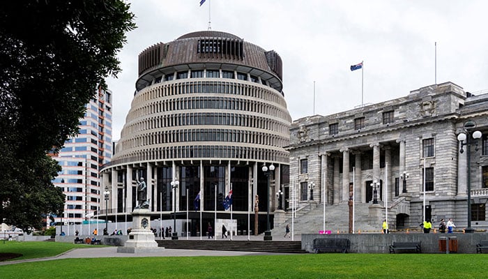People walk next to The Beehive, the executive wing of the New Zealand Parliament Buildings, in Wellington, New Zealand, September 24, 2025. — Reuters