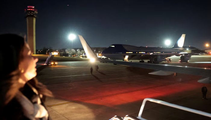A White House staff member looks back at Air Force One while boarding a replacement plane, also designated Air Force One, after making an unscheduled return landing due to an electrical problem identified mid-flight en route to Davos, Switzerland, at Joint Base Andrews, Maryland, US, January 20, 2026. — Reuters