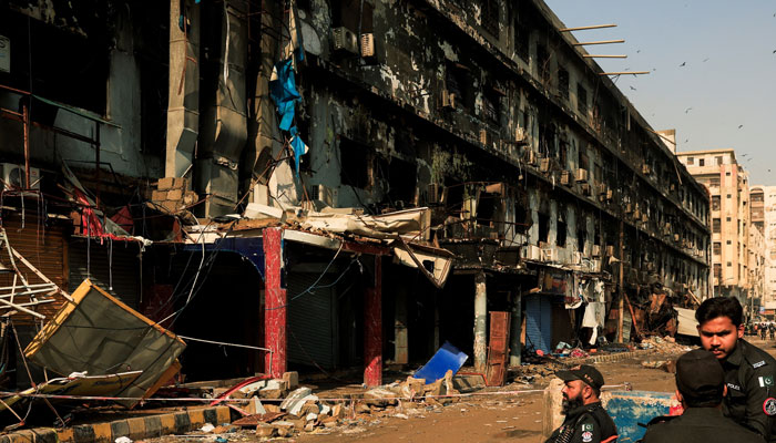 Police officers guard the site, following a massive fire that broke out at the Gul Plaza Shopping Mall, in Karachi, January 21, 2026. — Reuters