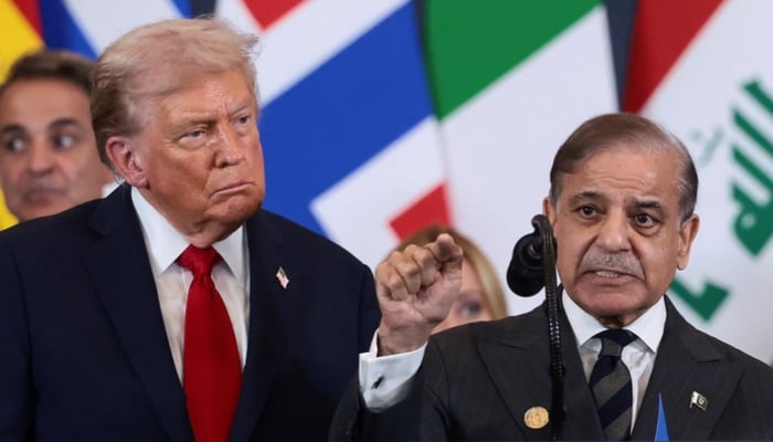US President Donald Trump looks at Prime Minister Shehbaz Sharif speaking following the official signing of the first phase of the Gaza ceasefire agreement between Israel and Hamas. — Reuters