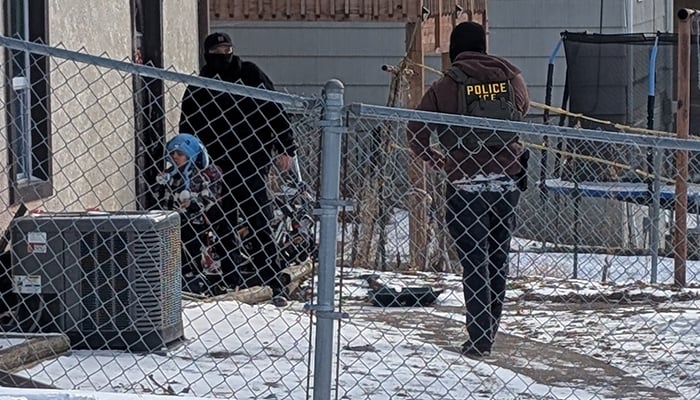 ICE agents stand next to a boy, who a witness identified as Liam Conejo Ramos, a five-year-old that school officials said was detained in Minneapolis, Minnesota, US, January 20, 2026. — Reuters