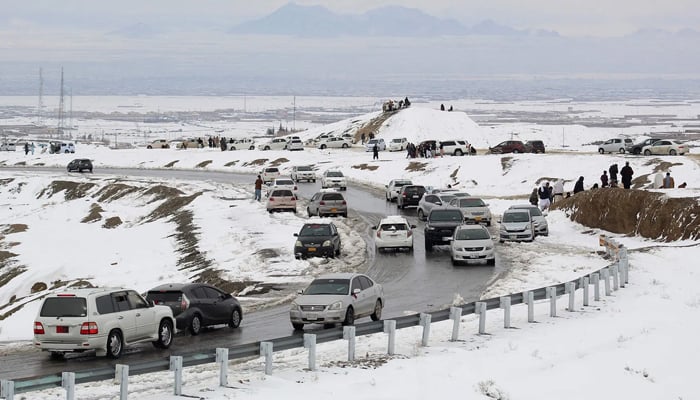 Commuters drive through a snow-covered road in Khyber Pakhtunkhwa’s Chaman on January 22, 2026. — AFP