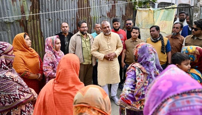 This photograph, taken on January 14, 2026, shows Bangladesh Nationalist Partys election candidate SM Zilany (centre) speaking with residents during a visit to his electoral constituency Gopalganj, Bangladesh. — AFP