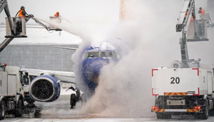 A de-icing crew works during winter storm Fern on a Southwest Airlines flight at Nashville International Airport in Nashville, Tennessee, US, January 24, 2026. — Reuters