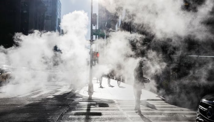 A pedestrian waits at a traffic light during cold weather in Midtown Manhattan, New York City, US, Jan. 21, 2026. — Reuters