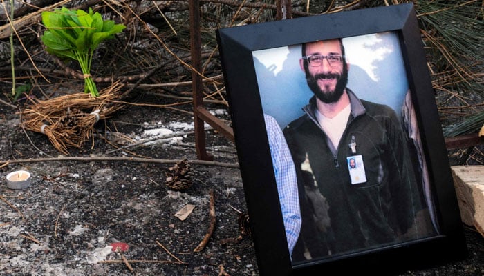 A photograph of 37-year-old Alex Pretti can be seen at a makeshift memorial in the area where he was shot dead by federal immigration agents earlier in the day in Minneapolis, Minnesota, on January 24, 2026. — AFP