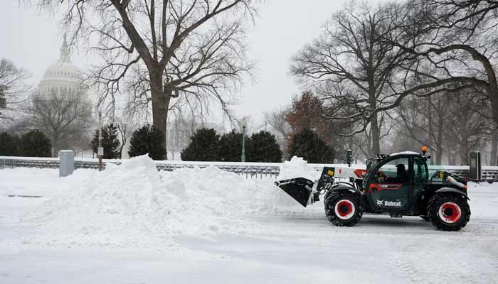 A snow removal vehicle clears snow in the Capitol Hill neighborhood as a major winter storm spreads across a large swath of the United States, in Washington, DC,US, January 25, 2026. — Reuters