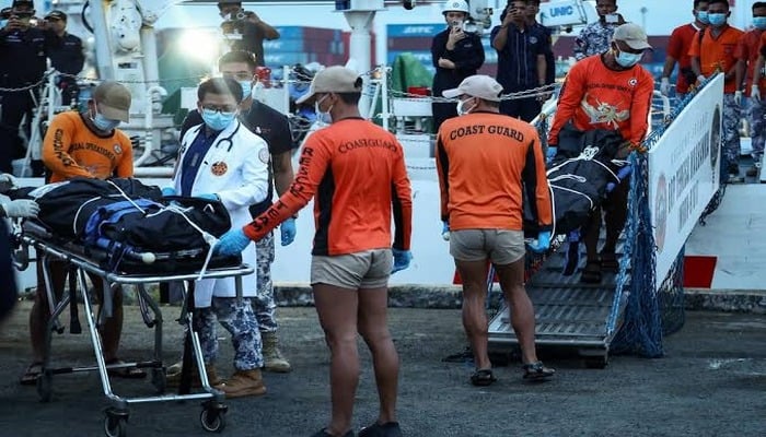 Philippine Coast Guard personnel carry body bags containing the remains of the crew members who died in the sinking of the cargo ship M/V Devon Bay, at the Port of Manila, Philippines, January 26, 2026. — Reuters