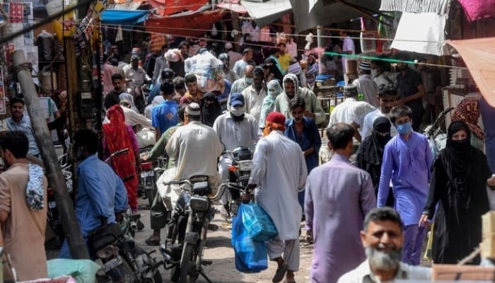 Residents shop at a wholesale market in Karachi. — AFP/FIle