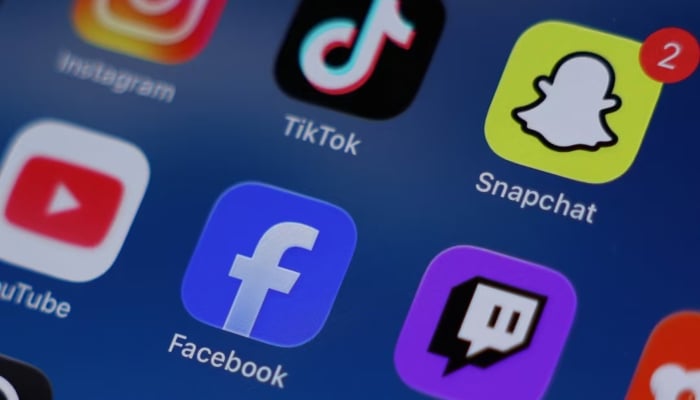 Instagram, TikTok, Snapchat, YouTube, Facebook, Twitch and Reddit applications are displayed on a mobile phone in this picture illustration taken on December 9, 2025. — Reuters