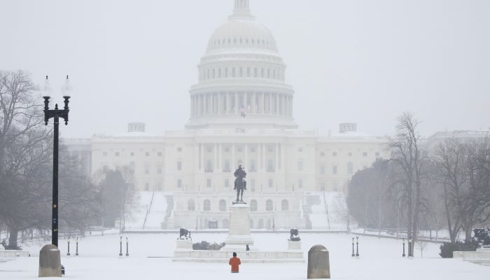 A view of the US Capitol as snow falls in Washington, DC, US, on January 25, 2026. — AFP