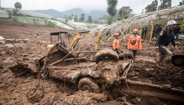 Rescuers search for victims buried by a landslide in Pasirlangu village in Bandung, West Java, on January 26, 2026. — AFP