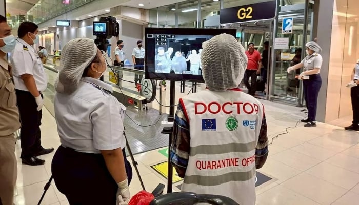 Airport health authorities wearing protective masks monitor passengers from international flights arriving at Suvarnabhumi International Airport in Bangkok, Thailand, January 25, 2026. — Reuters