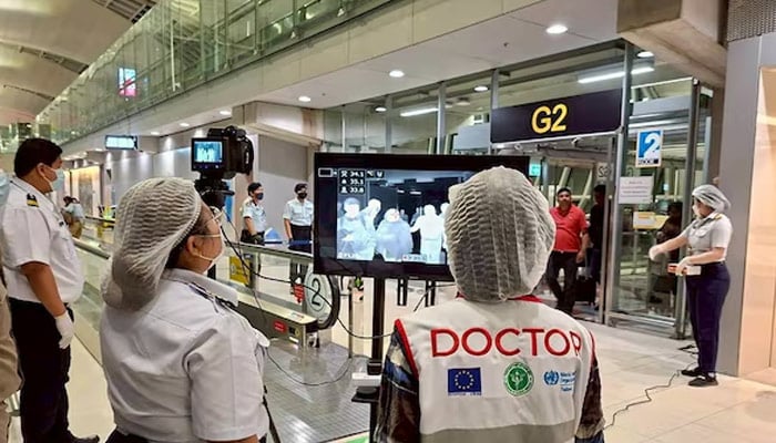 Airport health authorities wearing protective masks monitor passengers from international flights arriving at Suvarnabhumi International Airport in Bangkok, Thailand, January 25, 2026. — Reuters