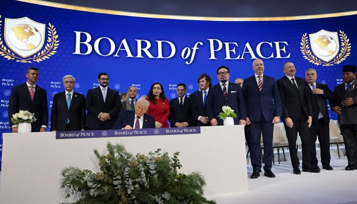 US President Donald Trump signs the Charter of the Board of Peace, during a charter announcement for Trumps Board of Peace initiative aimed at resolving global conflicts, alongside the 56th annual World Economic Forum (WEF), in Davos, Switzerland, January 22, 2026. — Reuters