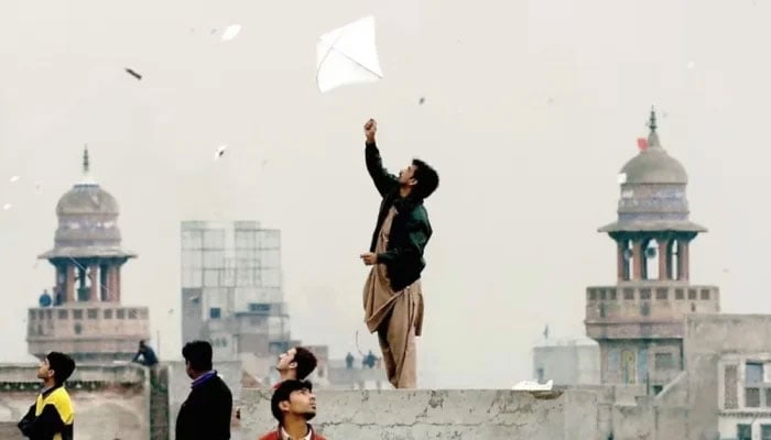 Pakistani youth enjoy flying kites during the Basant or kite flying festival in Lahore on February 6, 2005. — AFP