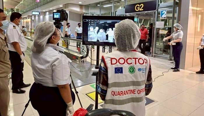 Airport health authorities wearing protective masks monitor passengers from international flights arriving at Suvarnabhumi International Airport in Bangkok, Thailand, January 25, 2026. — Reuters