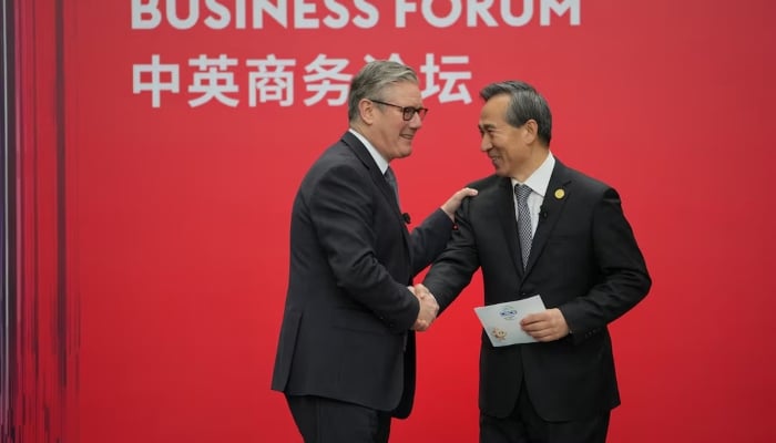 Britains Prime Minister Keir Starmer shakes hands with Ren Hongbin, Chairman of the China Council for the Promotion of International Trade (CCPIT), during the UK-China Business Forum in Beijing, China, January 30, 2026. — Reuters