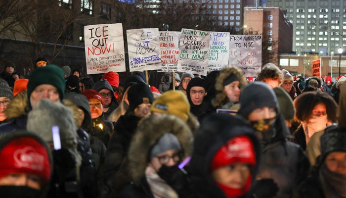 People hold signs and candles during a vigil for Alex Pretti, a 37-year-old nurse who was fatally shot by immigration agents in Minneapolis, at the Veterans Affairs NY Harbor Healthcare System Manhattan Campus in New York, on January 29, 2026. — AFP