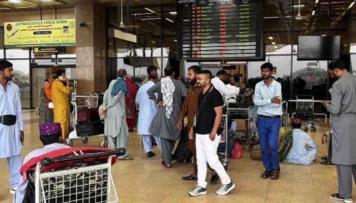 Passengers wait at the Jinnah International Airport after all domestic and international flights were cancelled in Karachi, May 7, 2025. — AFP