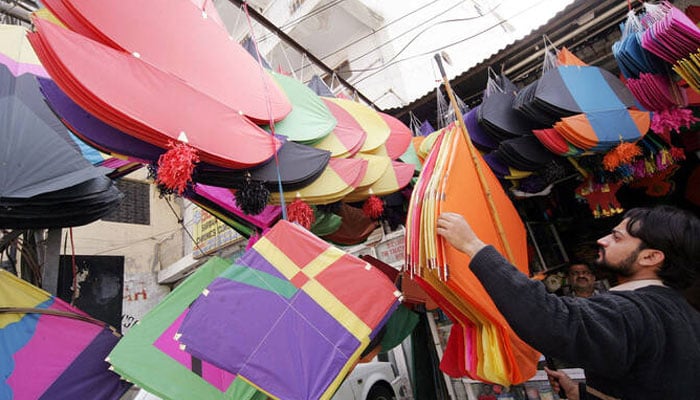 A Pakistani shopkeeper displays kites at a kite market in Rawalpindi, near the capital Islamabad, February 28, 2005. — Reuters